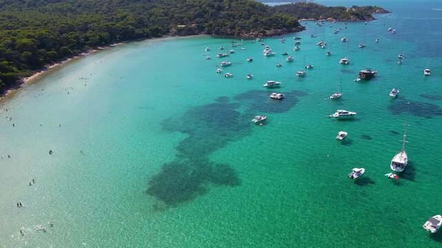 Notre Dame Beach, Cote d&acute;Azur, France, aerial view. Drone circling above the bay. Yachts and boats in the middle of the bay. Famous travel destination in South of France. Turquoises water colour.