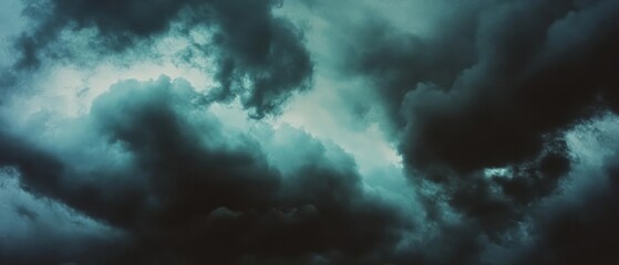 Fototapeta premium Dark clouds swirl ominously in the sky, creating a dramatic and intense atmosphere