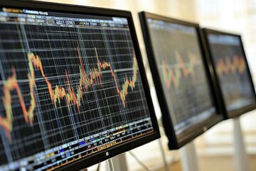 computer monitors displaying stock market graphs. The screens are black and the graphs are colorful. Scene is serious and focused, as the graphs show the fluctuations of the stock market