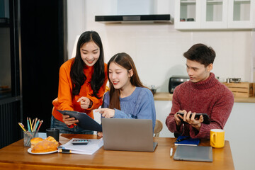 Teamwork and creativity with sitting working at kitchen table young collaborating