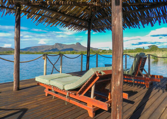 Relaxing beside Mkuze Dam beneath Ghost Mountain.
