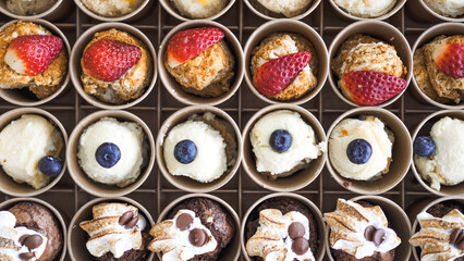 Cakes in cups (honey cake with strawberries, cheesecake with blueberries, tiramisu)