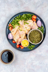 Raw chicken breast fillet with cilantro.