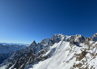 Mont Blanc massif towering over snowy landscape in Courmayeur, Italy