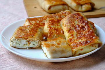 Thin pancakes with cottage cheese, rolled into a tube. A festive dish for the pagan Slavic holiday Maslenitsa
