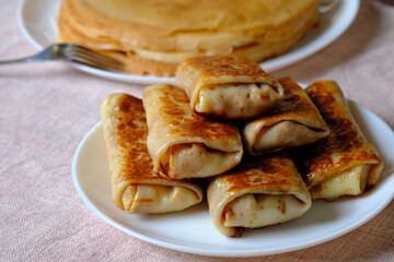 Thin pancakes with cottage cheese, rolled into a tube. A festive dish for the pagan Slavic holiday Maslenitsa