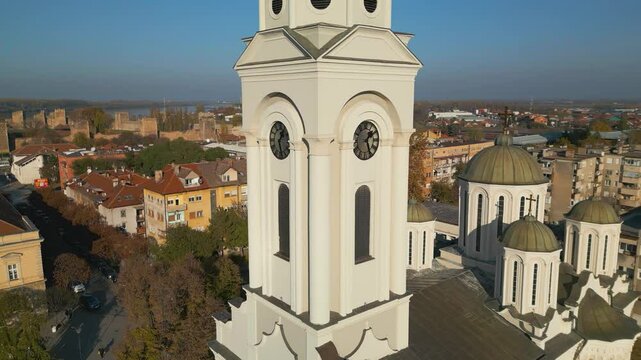  4K Aerial cinematic view of Smederevo city: St. George Church and the massive medieval fortress on the Danube river bank, Serbia. Historic panorama at sunset.