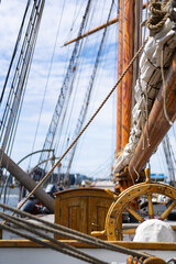 Closeup of ship wheel and rigging outdoors