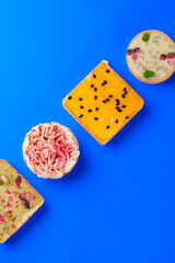 top view of Assorted Gourmet Mini Tarts on a Vibrant Blue Background