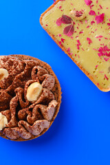 Pistachio Tart and chocolate and nuts tart on a Bold Blue Background