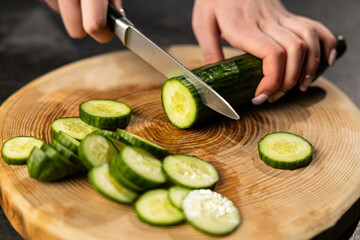 Fresh Cucumber Slicing on Wooden Cutting Board
