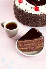 Chocolate Cherry Cake Slice with Coffee on Pink Background
