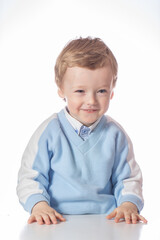 Emotional baby in shirt and blue jumper on white background