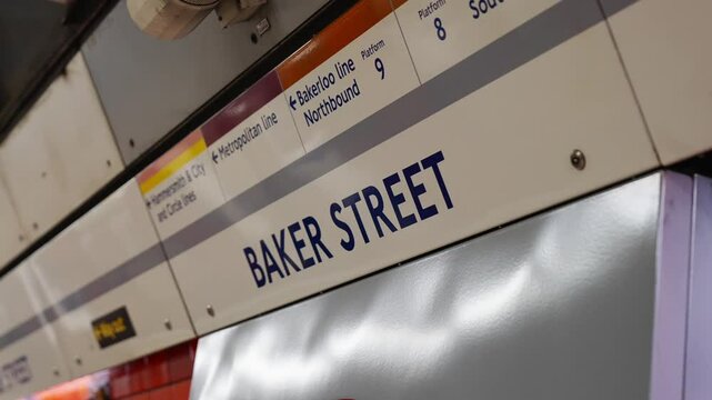 A sign for Baker Street is on a train. The sign is blue and white