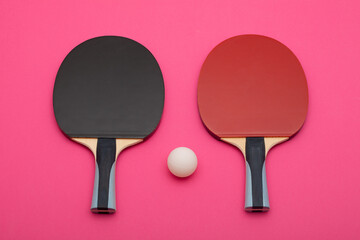 Professional Table Tennis Paddles and Ball on Vibrant Pink Background