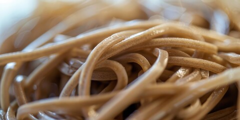 Close-up of dry noodles, ready for cooking. This could be a type of spaghetti or macaroni.