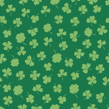 Shamrock or clover leaf flat design green seamless pattern falling leaves on white background vector illustration. Irish holiday celtic St Patrick day motif seamless pattern with shamrock clover leaf.