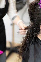 Fototapeta premium Cold hair restoration on textured curls in a salon