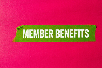 Member benefits message written on ripped torn green paper tape on pink background. Conceptual member benefits symbol. Copy space.
