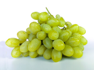 Isolated grapes bunch. Green or yellow grapes with leaves isolated on white background