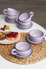 Ceramic mug with saucer on kitchen light table