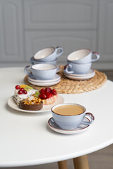 Ceramic mug with saucer on kitchen light table