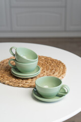 Ceramic mug with saucer on kitchen light table