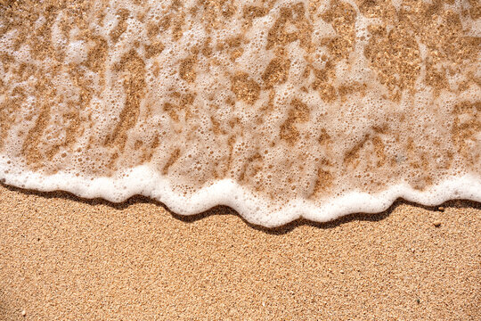 Aesthetic minimalism background on the theme of summer sea holidays on the beach. Sand texture With wave
