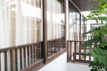 Modern curtain with sofa in hotel room wooden decorate in earth tone tropical