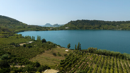 Aerial view of the lakeside of Lago d'Averno located in Pozzuoli, near Naples, Italy. It is a volcanic lake located in the Campi Flegrei. The lake is approximately circular.