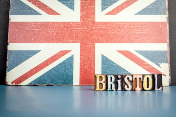 BRISTOL. Urban Area in Great Britain. Flag and alphabet letters on wooden texture background