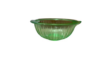 A vintage green glass mixing bowl isolated over a white background