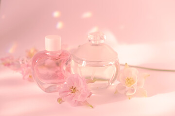 Elegant Perfume Bottle with Flowers on Soft pink Background