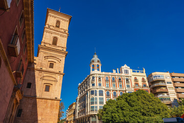 Fototapeta premium Several buildings such a church and residential conform a generic cityscape in Murcia City, Spain