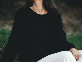 A stylish and moody portrait of a woman in an oversized black shirt, highlighting soft textures.