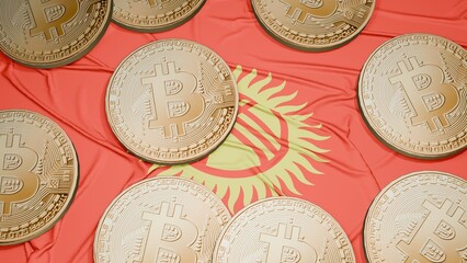 Several bitcoins are laid out on the flag of Kyrgyzstan