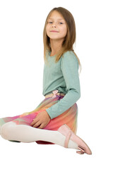 A girl child with light brown hair poses sitting on a transparent background. She is wearing a...
