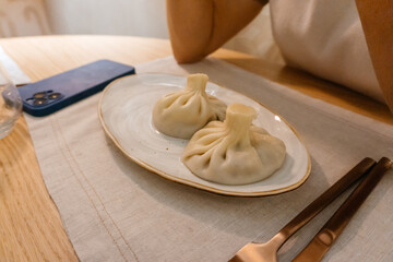 Georgian khinkali on a white plate. hot Georgian lunch