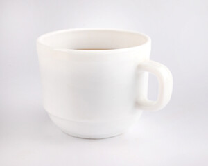 White cup with tea on a white background.