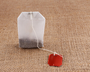 Tea bag on a cloth surface.