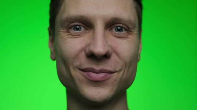 The young man smiles. Portrait of male who happy about something. Positive emotions. Guy isolated on green chroma key background