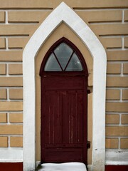 old wooden locked door with an arch in a church in Belarus