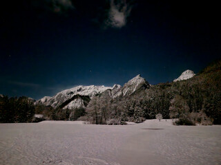 landscape with high mountains. snow karst on the pointed peaks of the limestone mountains. cottages...
