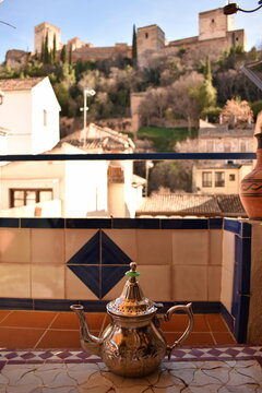 Arabic teapot against the backdrop of a Moorish fortress
