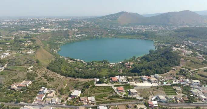 Aerial view of Lake Avernus (Lago d'Averno) located Pozzuoli, near Naples, in Campania, Italy. It is a volcanic crater lake located in Phlegraean Fields (Campi Flegrei). The lake is roughly circular.