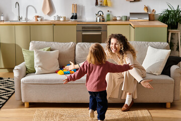 Curly-haired mother delights in a joyful embrace with her daughter at home.