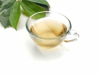 Soursop leaf boiled water in glass on white background, healthy drink lifestyle.