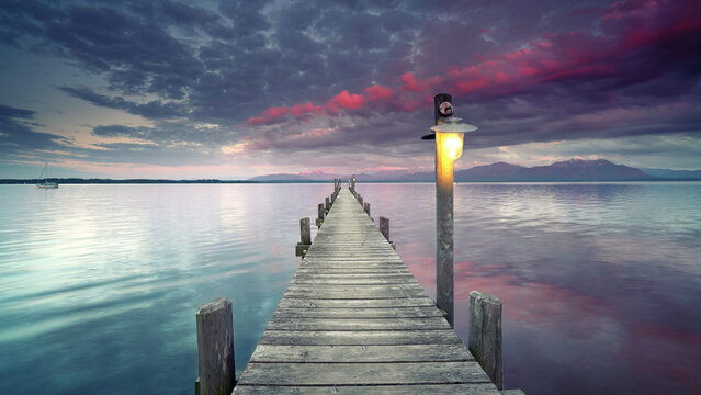 stunning sunset light on old wooden pier over calm lake - Powered by Adobe