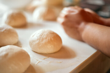 Preparation homemade pizza on kitchen table.