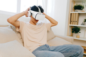 Virtual reality experience, casual indoor setting, young person with VR headset, engaging with...